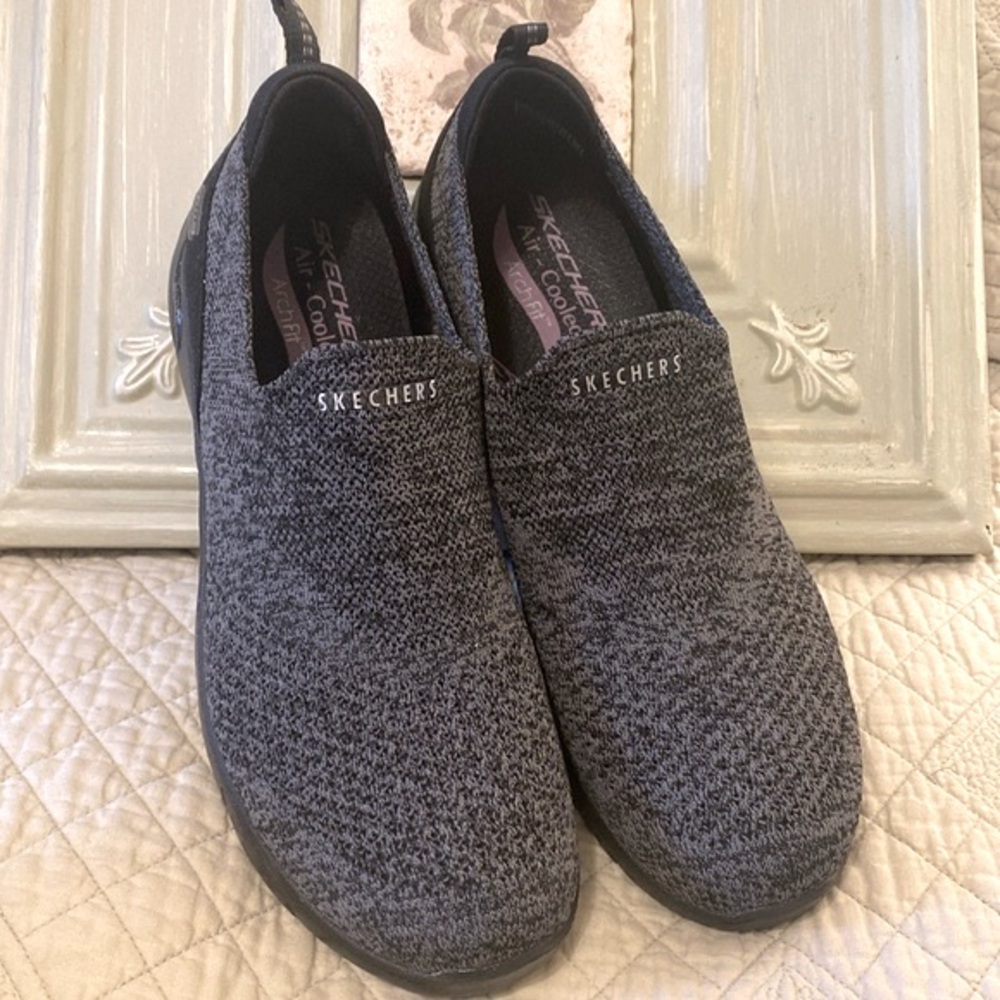Sketchers slip on grey athletic shoes.